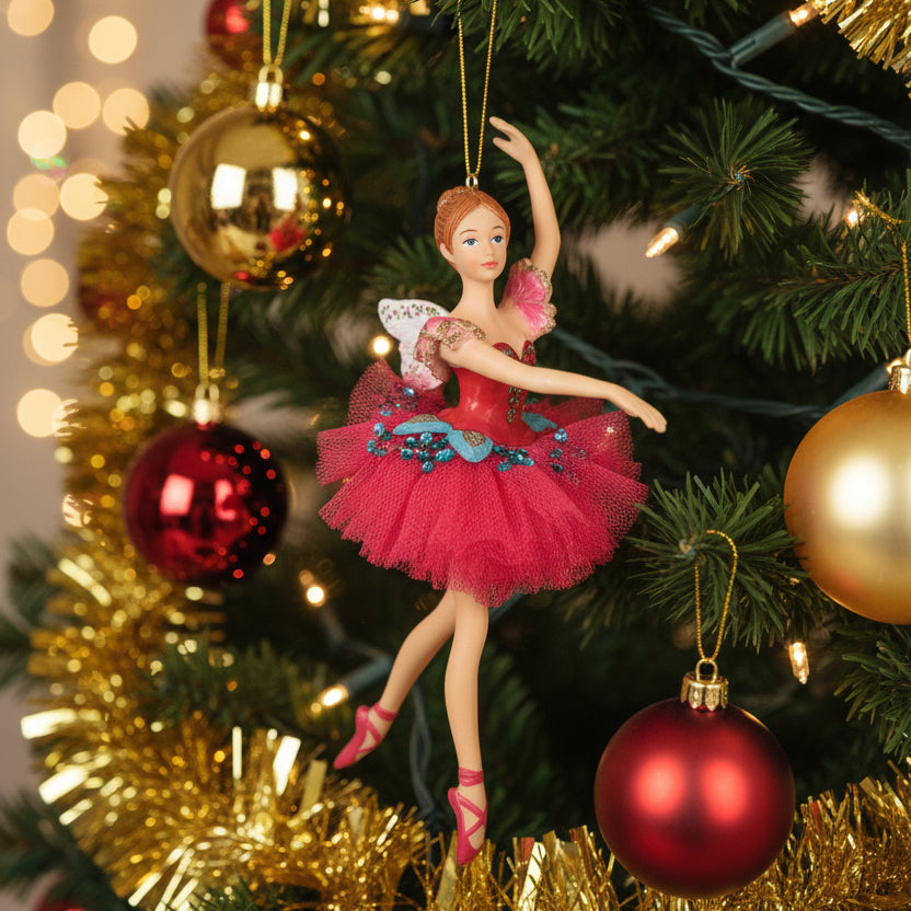 Ballet dancer figurine in a red dress with floral details on a white background