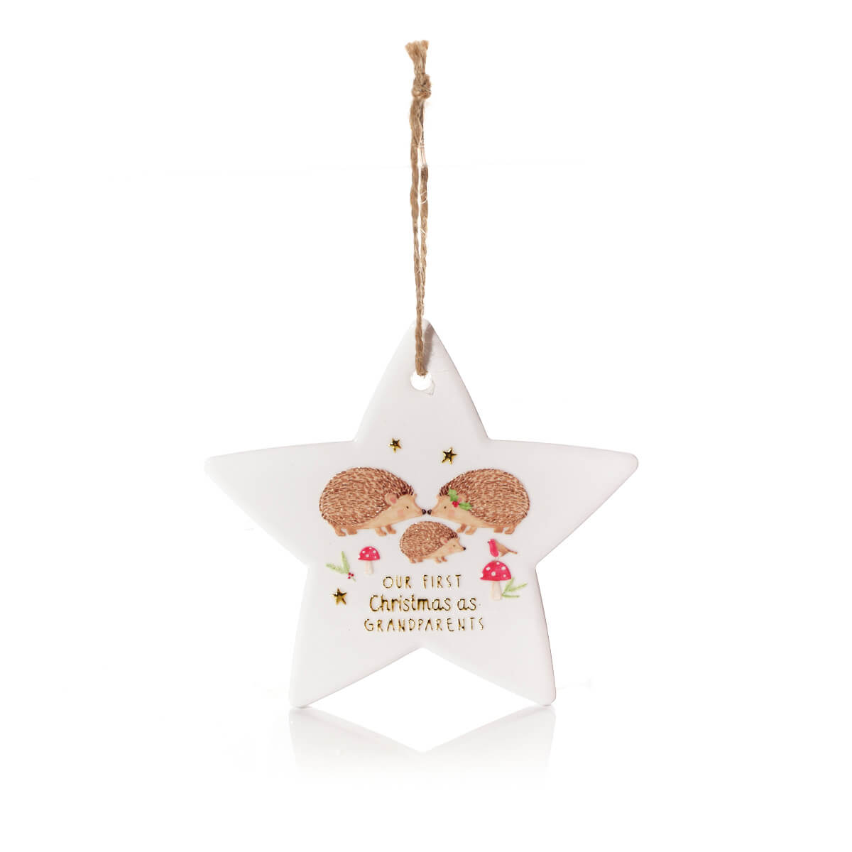 A white five-pointed star Christmas ornament with a hanging twine loop, featuring an illustration of three hedgehogs and the text 'OUR FIRST Christmas as GRANDPARENTS' on a clean white background.