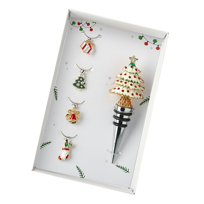 A set of wine glass charms and a bottle stopper with Christmas tree design, presented on a white background.