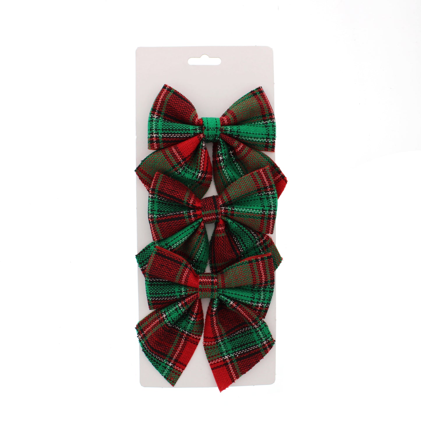 Three plaid ribbon bows in a red and green tartan pattern, attached to a white cardboard hanger card against a plain white background.