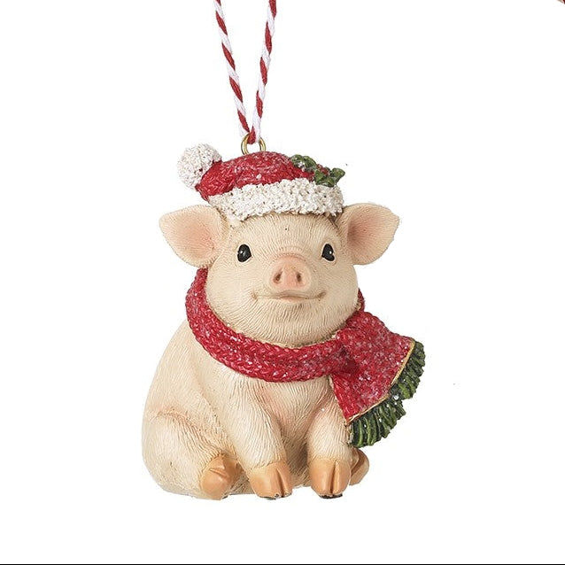 hanging festive pig, wearing a Santa hat and scarf on a white background