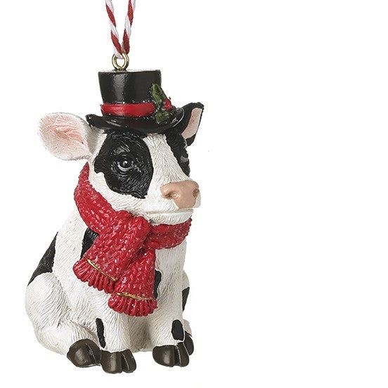 hanging festive cow, wearing a black top hat and scarf on a white background