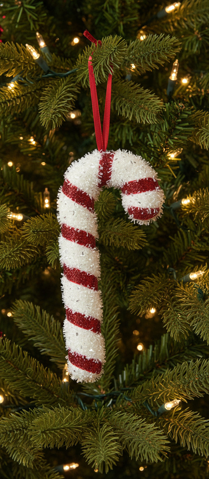 A red and white tinsel candy cane Christmas tree decoration with a glittery tinsel effect and a red hanging ribbon.