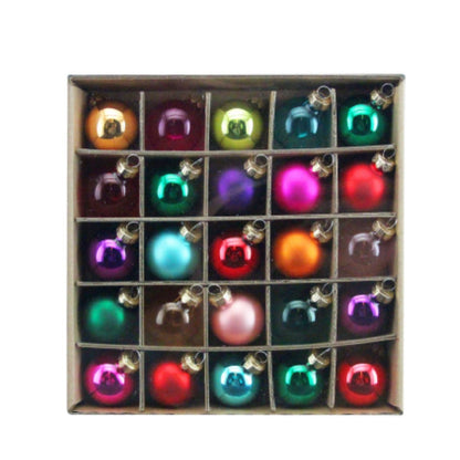 Box of colorful Christmas tree ornaments on a white background