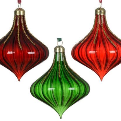 Two red and green glass ornaments hanging against a white background