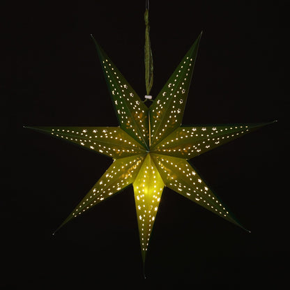 A glowing seven-pointed paper star Christmas ornament with small illuminated dots along its edges, hanging against a solid black background.