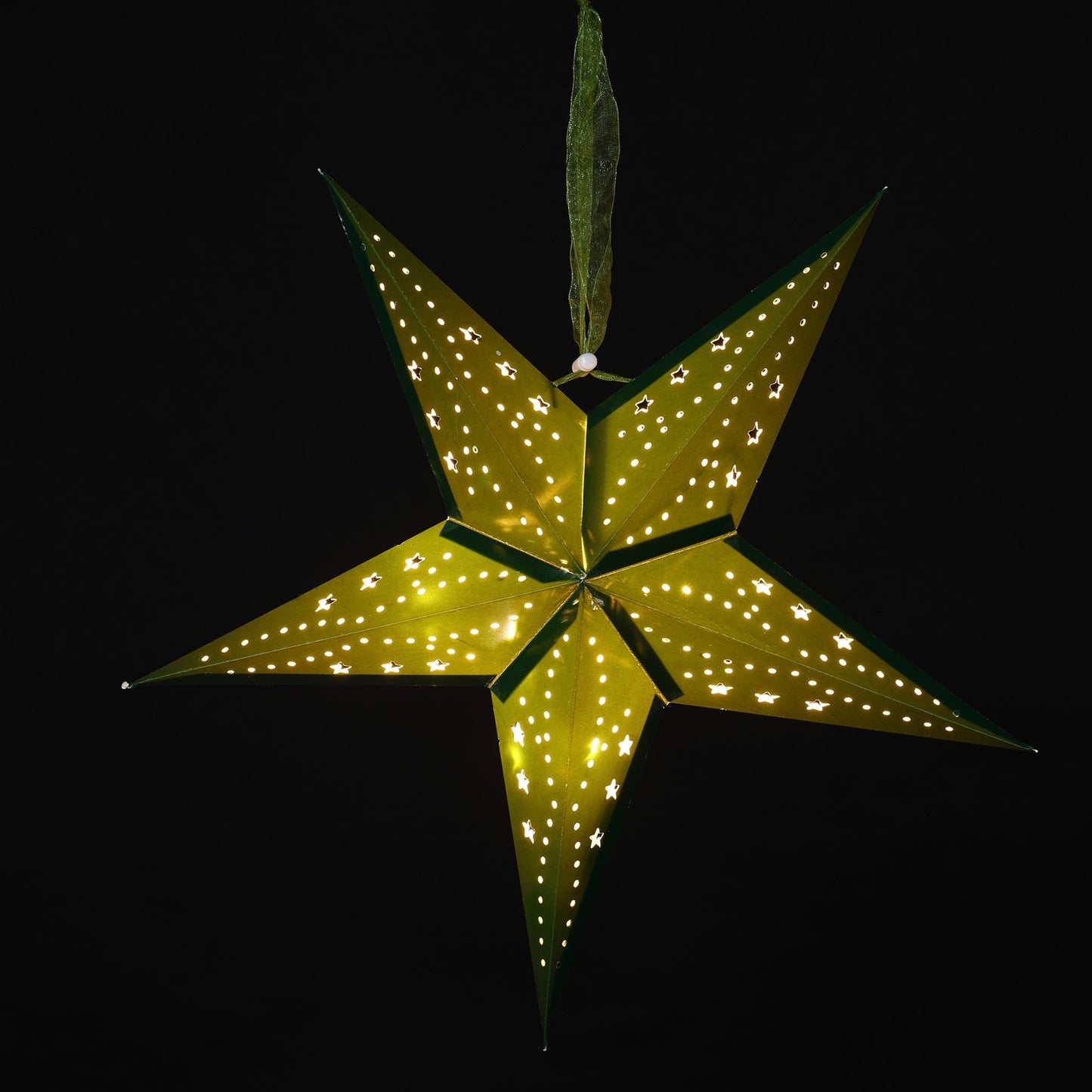 A glowing five-pointed star ornament with small illuminated dots along its edges and a hanging loop at the top, shown against a solid black background.