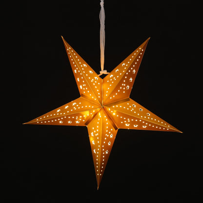 A glowing five-pointed star hanging ornament with laser-cut patterns, emitting a warm golden light against a solid black background.