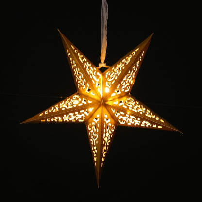 A glowing five-pointed star hanging ornament with intricate cutout patterns, emitting a warm golden light against a solid black background.