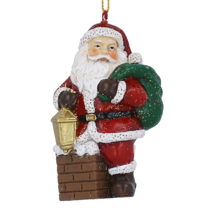 Decorative Christmas ornament of Santa Claus in a Chimney with gold lantern and green sack on a white background