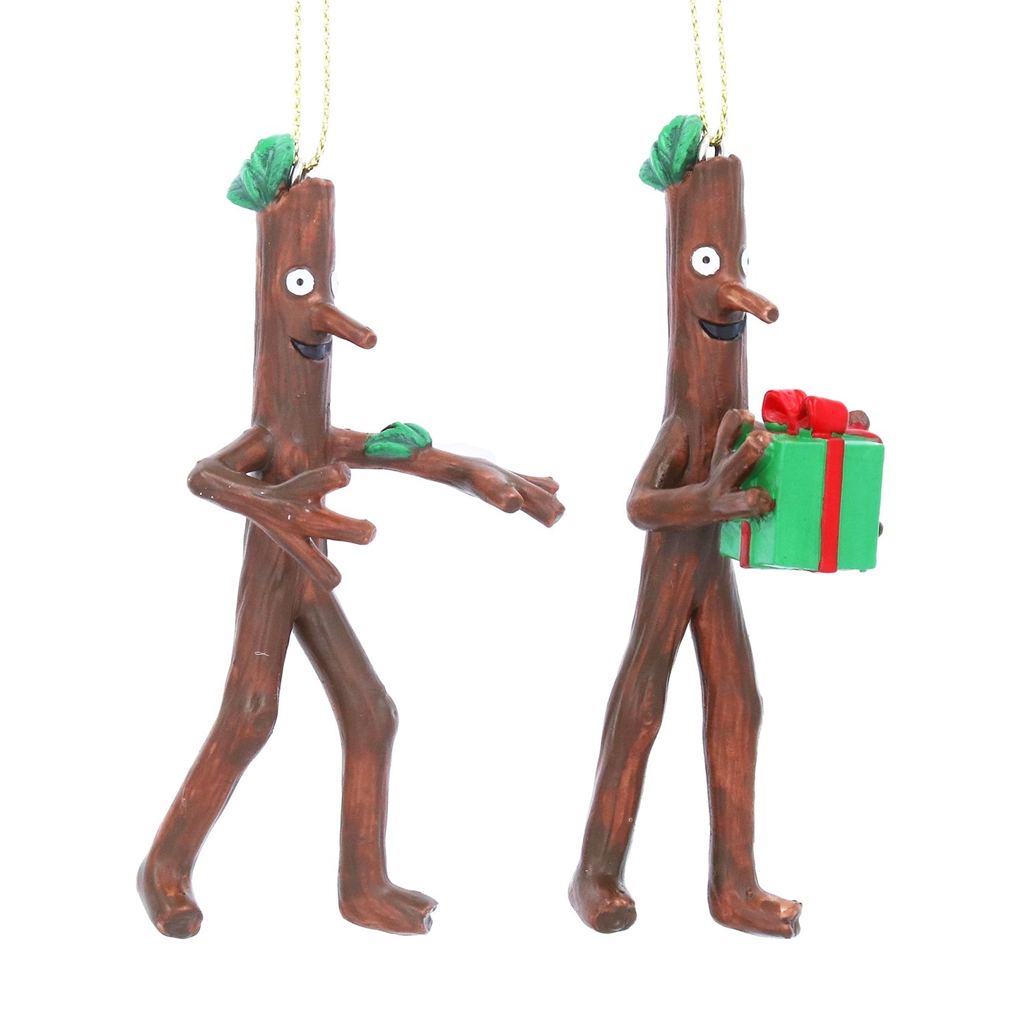 Two resin stick figure ornaments, one holding a gift, on a white background.