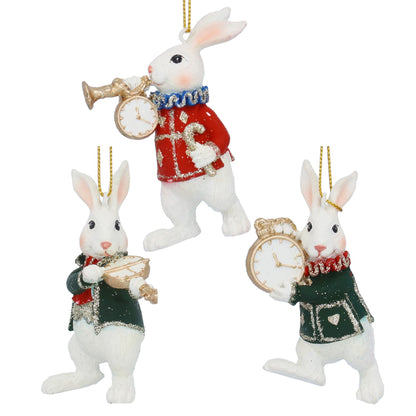 Three decorative rabbit ornaments with clocks and scarves on a white background