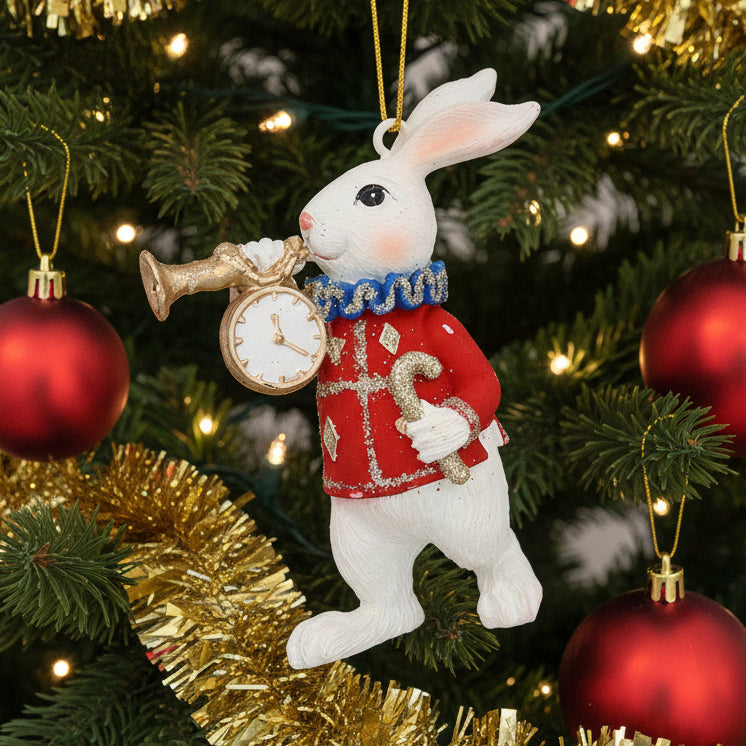 Decorative rabbit ornament holding a clock and horn hanging in Christmas tree