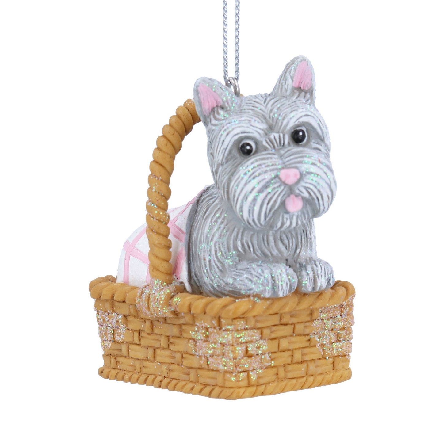 Toto dog figurine in a basket with a checkered blanket on a white background