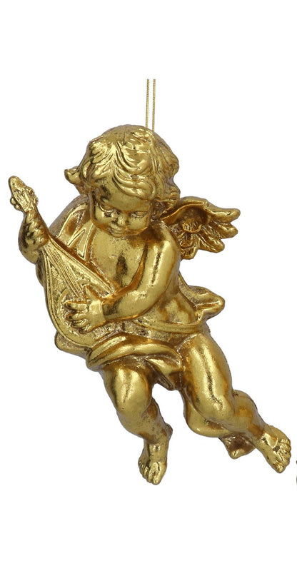 Gold-colored cherub figurine with a lyre on a white background