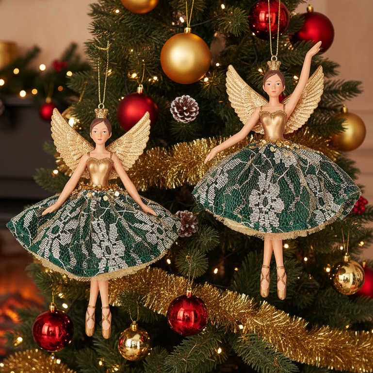 Two Christmas angel ornaments hanging on a decorated Christmas tree. The ornaments feature gold wings and bodices with green and white floral lace skirts, set against a background of a lit Christmas tree with gold and red ornaments.
