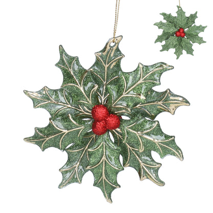 Decorative holly leaf ornament with red berries on a white background