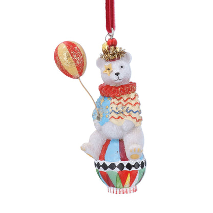 A festive white resin teddy bear Christmas ornament sitting in a colourful hot air balloon and holding a red-and-gold balloon, with a red hanging ribbon at the top.