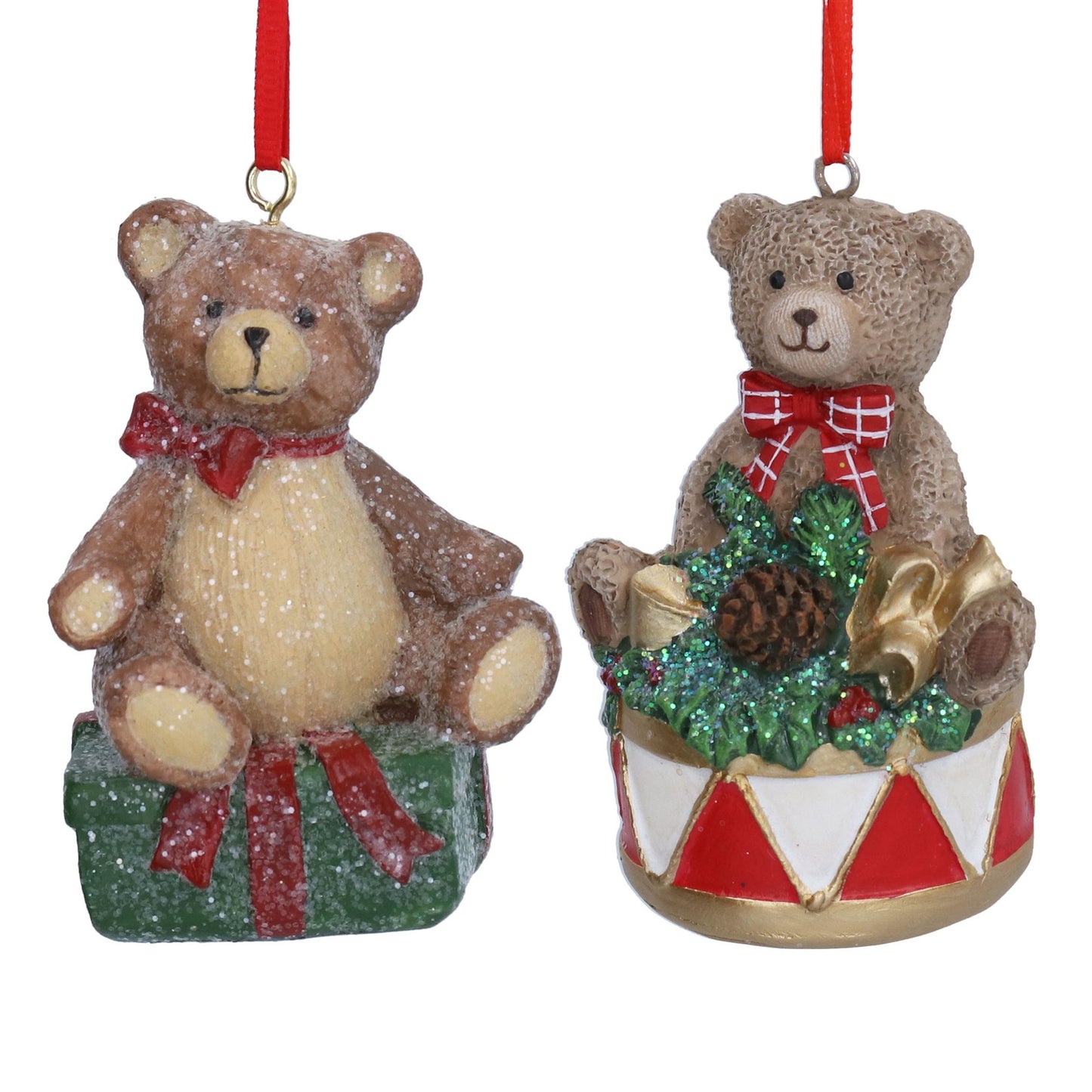 Two teddy bear Christmas ornaments on a white background