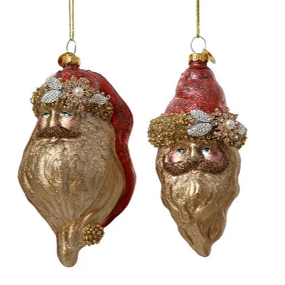 Two decorative Santa Claus ornaments with red hats and gold beards on a white background.