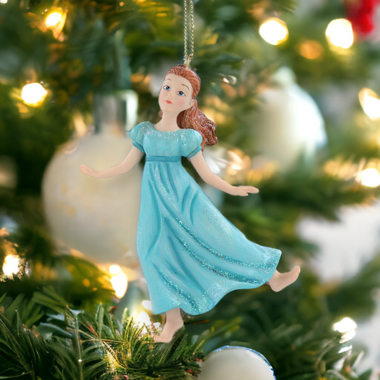 A resin figurine of the character Wendy from Peter Pan, in a blue dress with a sparkling gold hanging wire, placed on a Christmas tree.