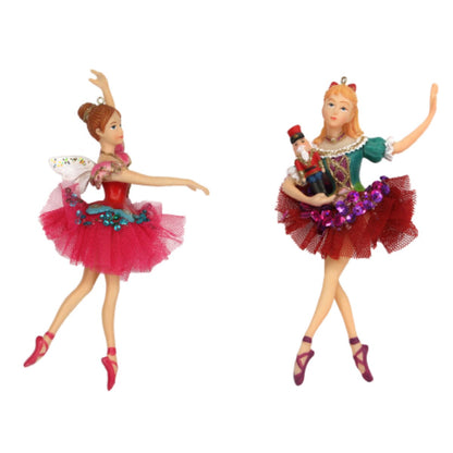 Two resin figurines of ballerinas in Christmas tree decorations, one in pink with a white flower and the other in red with purple flower accents.