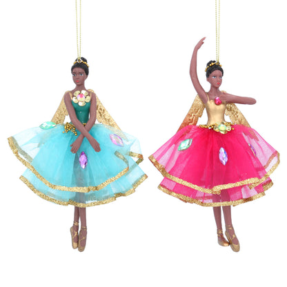 Two holiday ornaments featuring fairy figures in blue and pink tutus with gold accents and magical wings, hanging from gold wires.