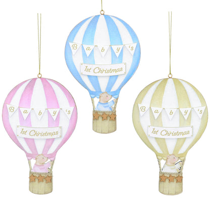Three wooden tree decorations shaped like balloons with the text 'It's Christmas' or 'Baby's First Christmas'. They are in blue, pink, and yellow colors.