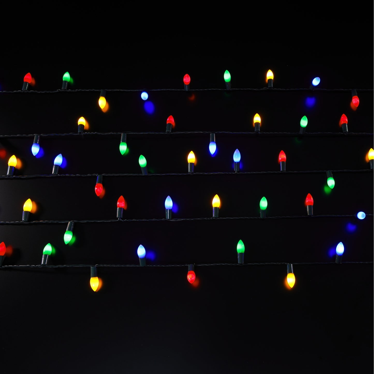String of multicolored Christmas lights on a black background