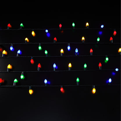 String of multicolored Christmas lights on a black background