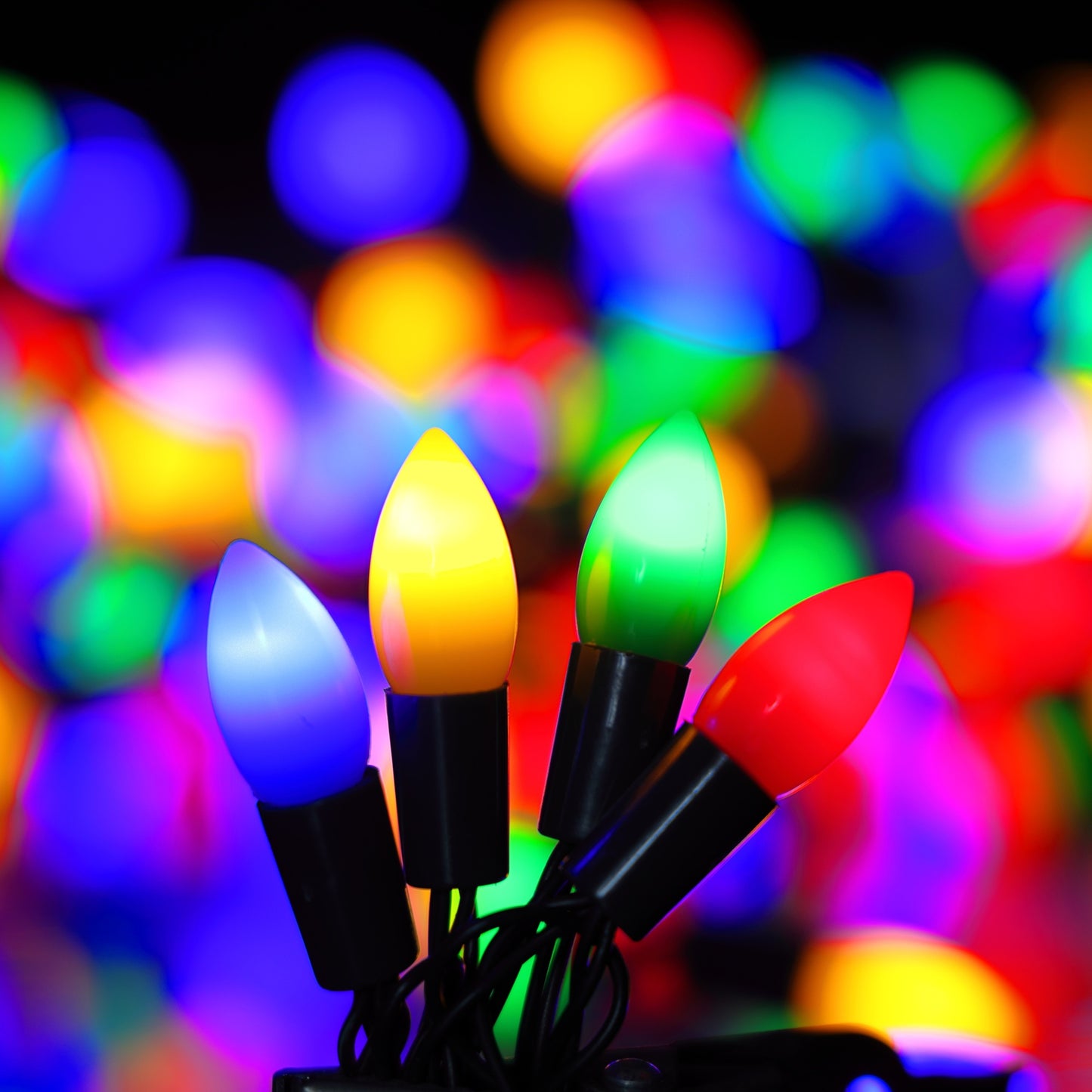 Multicolored Christmas lights with a blurred colorful background