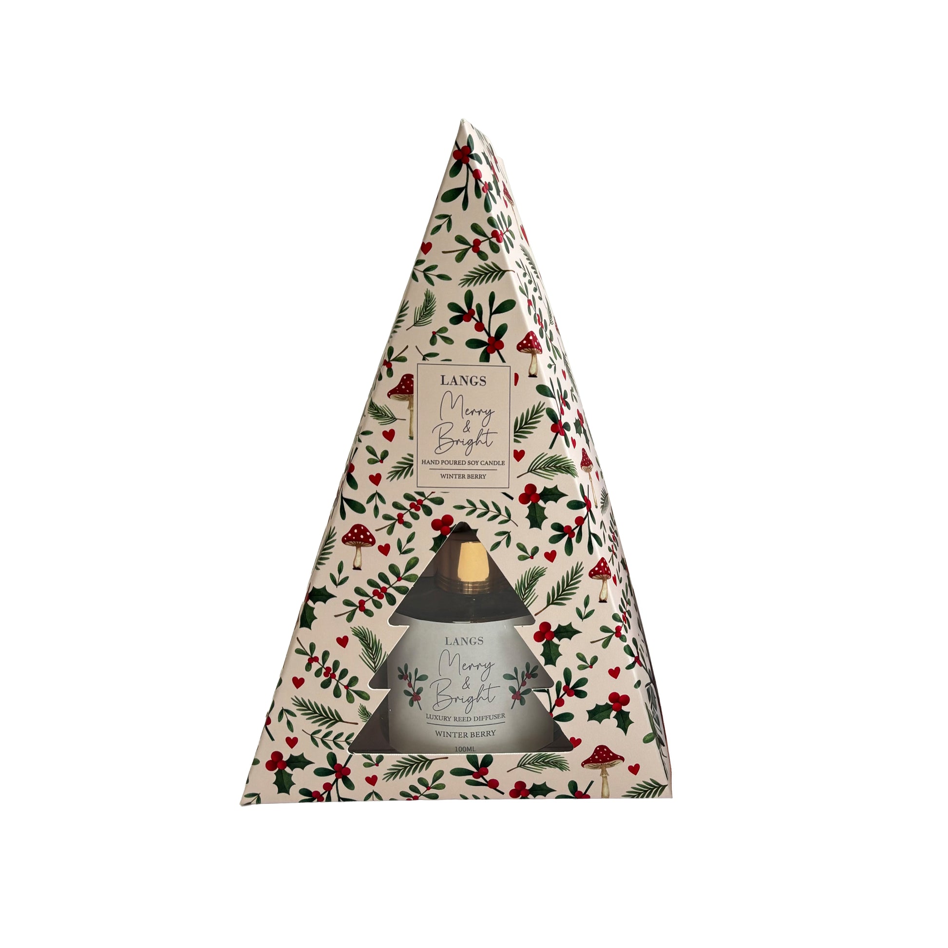 A triangular candle gift box from Langs, featuring a festive Christmas holly and berry pattern on a cream background, with a clear window showing product