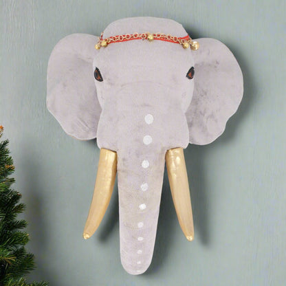 A fabric wall plaque depicting a gray elephant with gold tusks and a decorative red and gold headdress.
