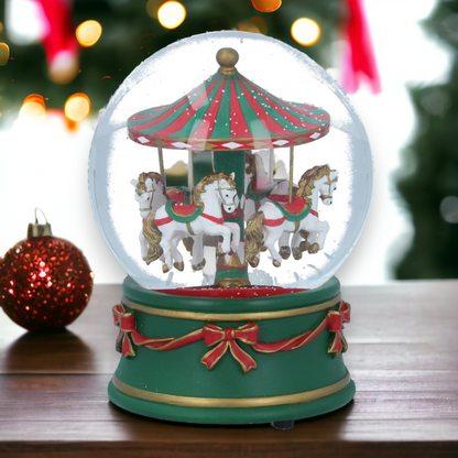 A musical Christmas snow globe featuring a carousel with horses and riders, encased in a transparent glass sphere with a green and red decorative frame.