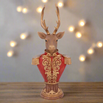 A decorative Christmas ornament featuring a stag head bust with a red and gold military-style jacket.