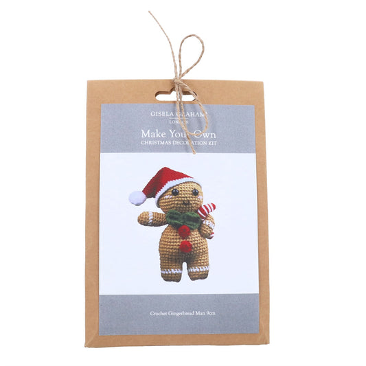 Gingerbread man decoration kit packaging with a gingerbread man wearing a Santa hat and scarf on a white background.