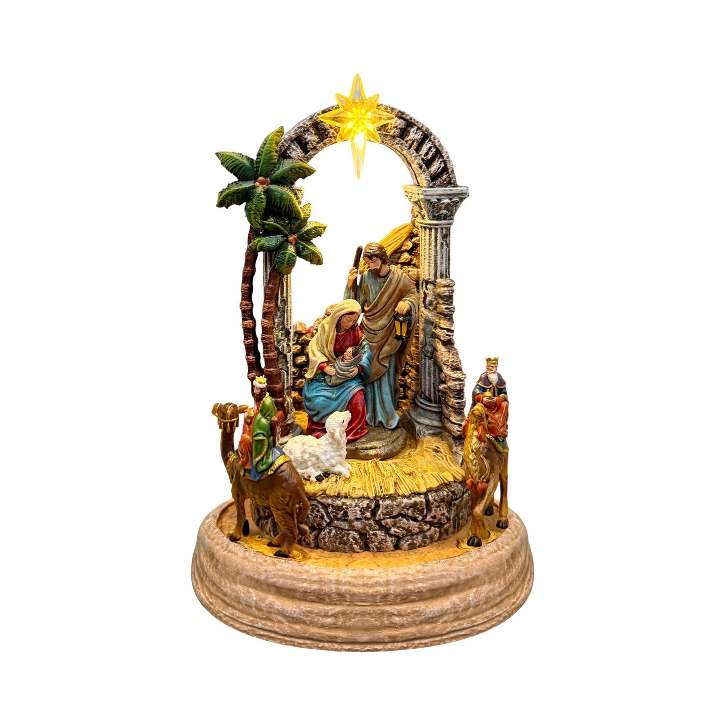 A nativity scene figurine set on a round stone-textured base, featuring Mary, Joseph, baby Jesus in a cradle, three wise men, a palm tree, and a glowing star under an arched backdrop, isolated on a white background.