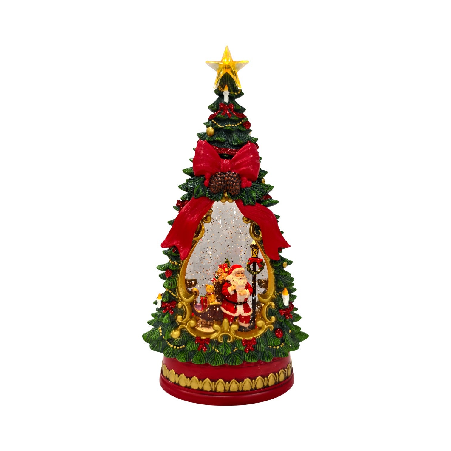 A festive tabletop Christmas tree water spinner decoration with a gold star topper, green branches, large red bows, a gold pinecone accent, and a snow globe featuring Santa Claus and a festive scene. The base is red with a gold patterned trim.