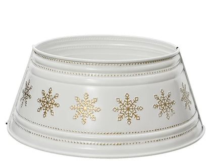 A white Christmas tree skirt with gold snowflakes embossed on it, with a collapsible metal frame.