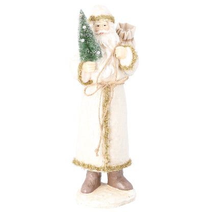 A festive Santa Claus figurine wearing a long cream robe with gold glitter trim, holding a small green Christmas tree and a sack, standing on a white base against a plain white background.