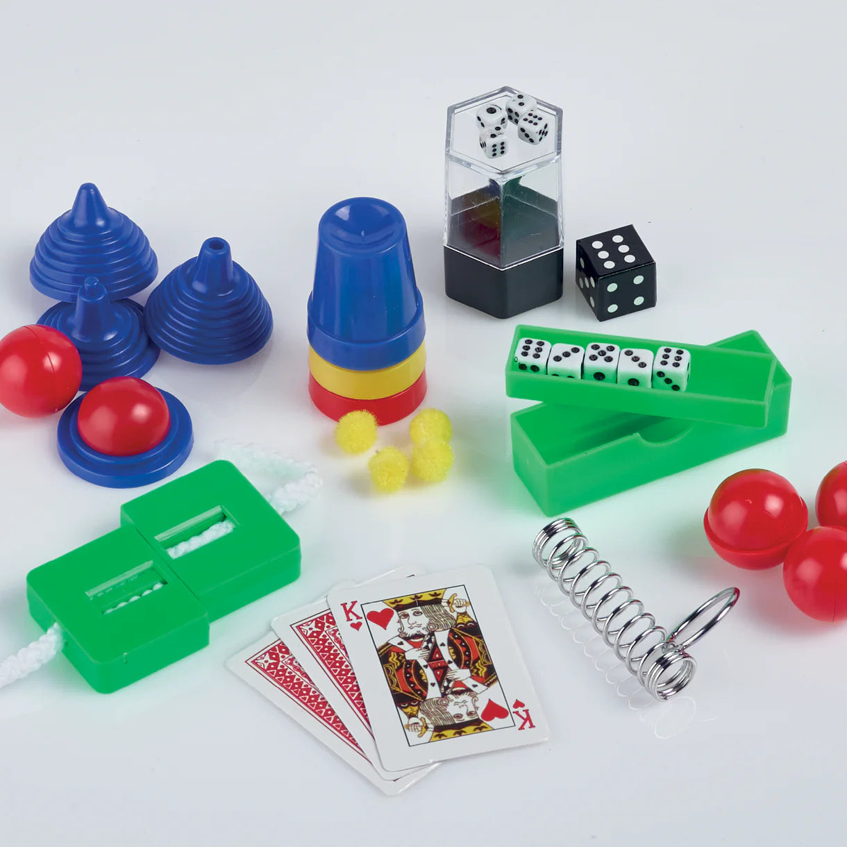 Assorted games and toys including cards, dice, and springs on a white background