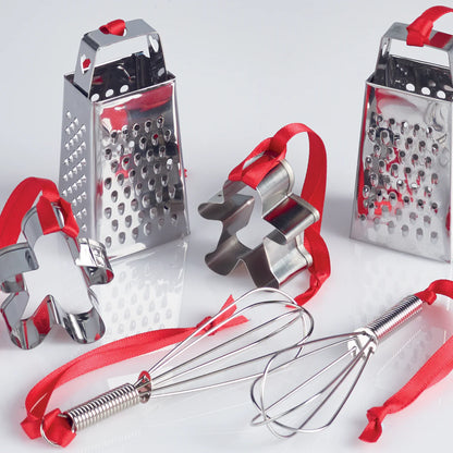 Set of kitchen tools including a box grater, whisk, and cookie cutters on a white background