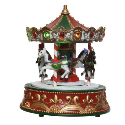 A colorful Christmas-themed musical carousel with figurines of horses and riders, decorated with multicolored LED lights and festive decorations.