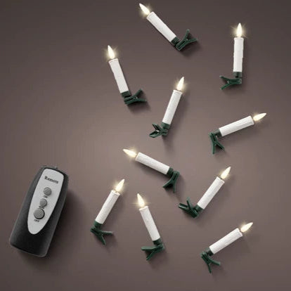 Set of Christmas lights with candles and a remote control on a brown background