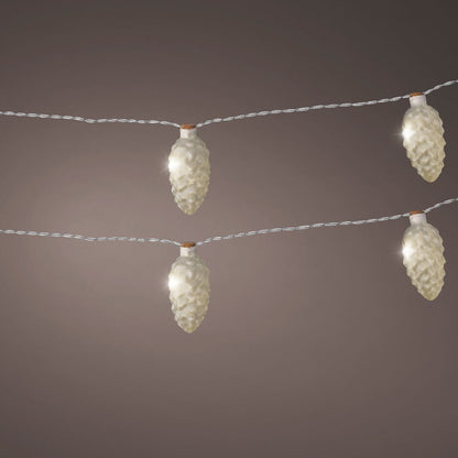 String lights with frosted pinecone shells emitting a warm white glow against a neutral background.