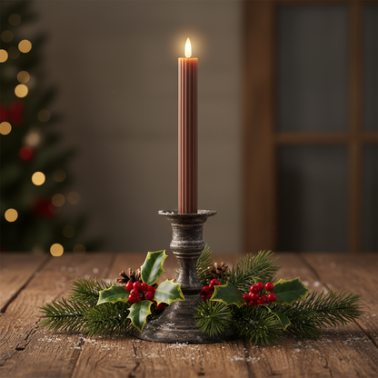 A tall brown candle with a carved design, featuring a white wick and a lit tip, against a dark background.