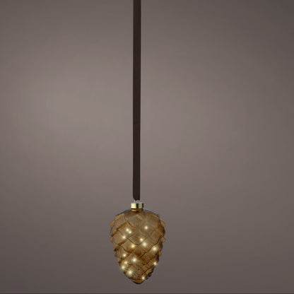 Decorative pendant light with a textured design on a dark background