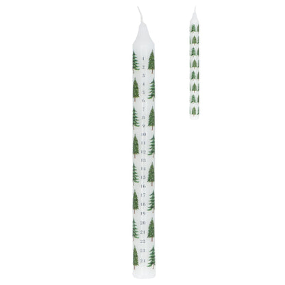 Two white candles with green tree pattern on a white background