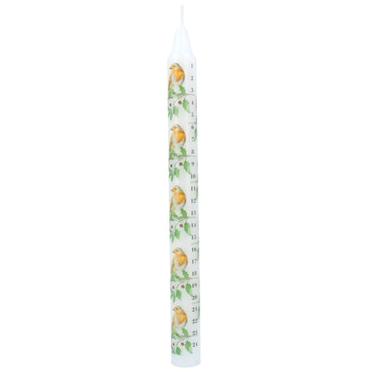 A tall, slender white taper advent candle printed with a repeating pattern of robins and holly and black numbers from 1 to 24