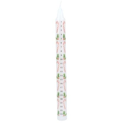 A single white taper candle with a vertical Christmas countdown design featuring green holly leaves, red candy canes, and black numbers from 1 to 24, shown on a plain white background.